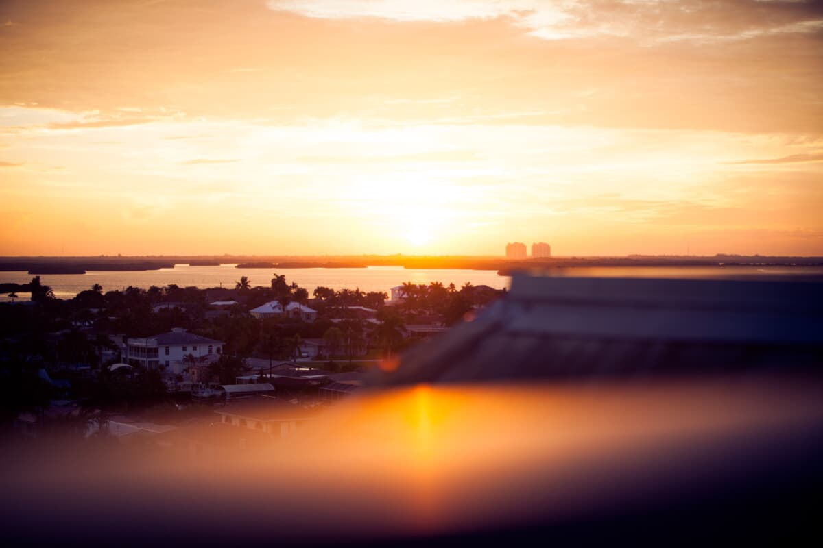 Warm evening light over a city and the water, photographed by Lex Aliviado